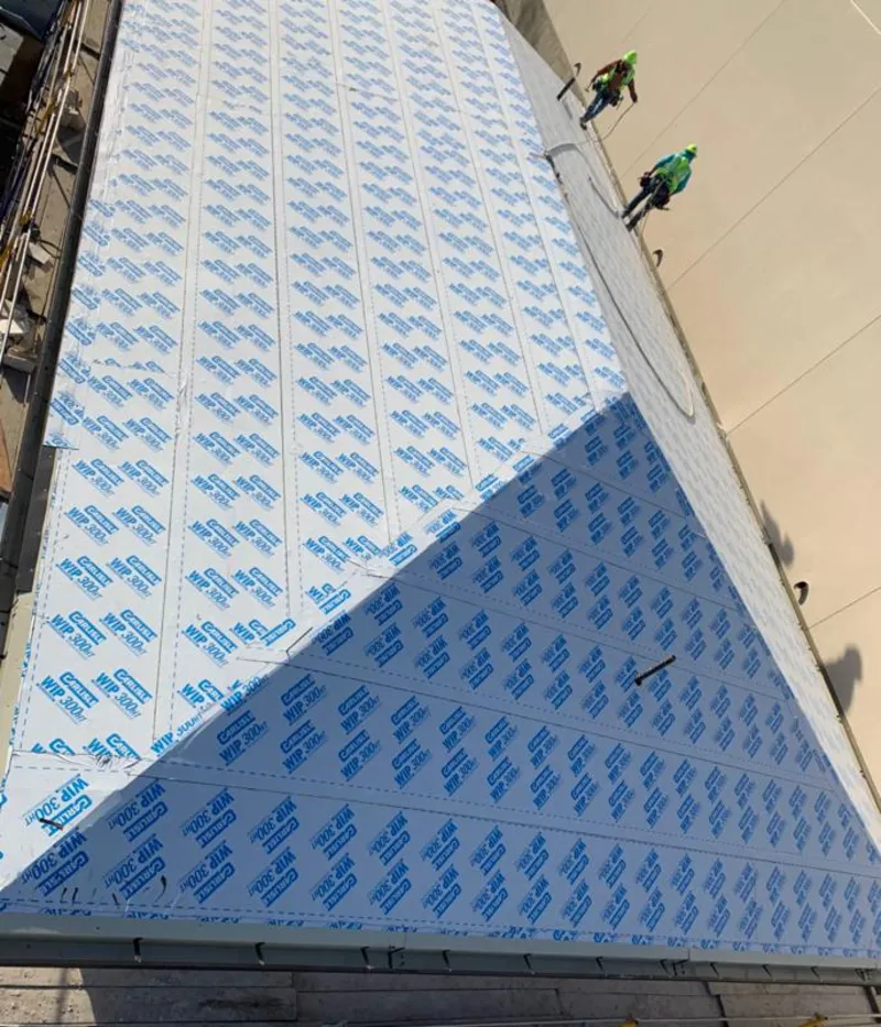 Professional roofers installing underlayment on a metal roof in Aberdeen